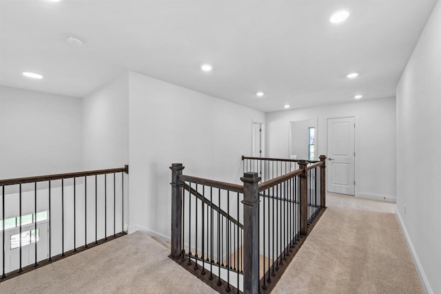 hallway featuring light colored carpet