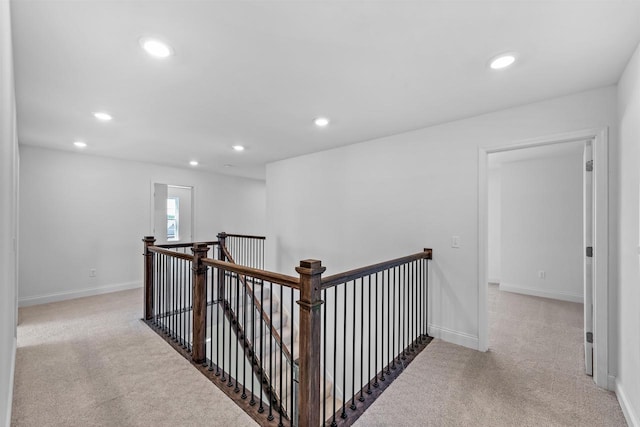 hallway featuring light colored carpet