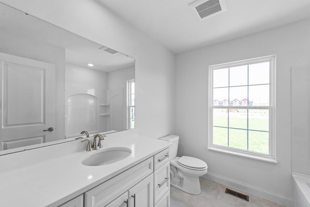 bathroom featuring tile patterned flooring, vanity, and toilet