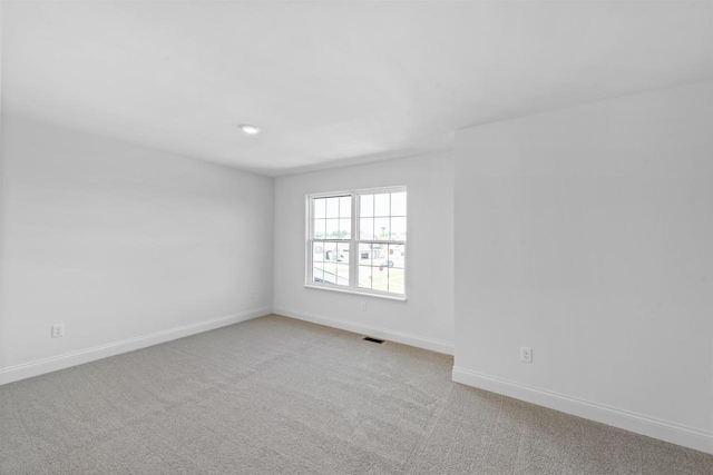 unfurnished room with light colored carpet