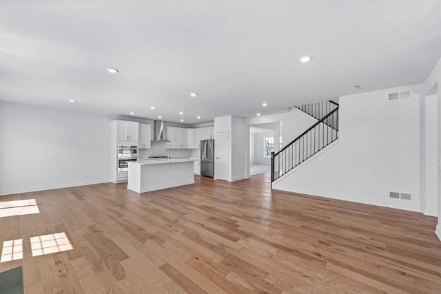 unfurnished living room featuring light wood-type flooring