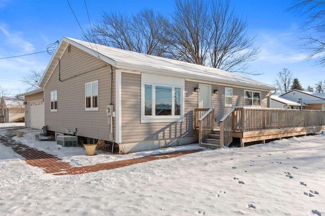 view of front of home with central AC and a garage