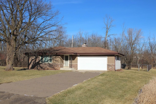 view of front of home with a front yard and a garage