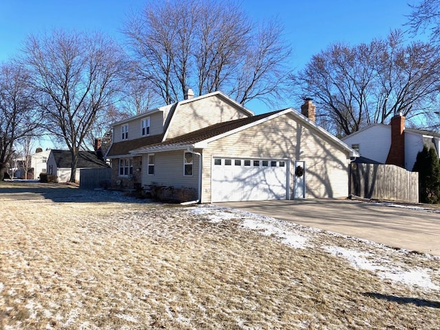 snow covered property featuring a garage