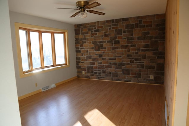 spare room with ceiling fan and light hardwood / wood-style flooring