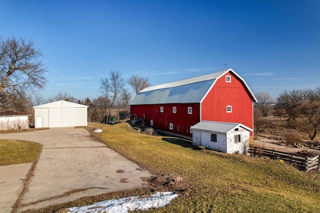 view of side of home with a lawn and an outbuilding