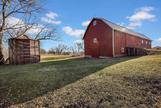 view of property exterior featuring a yard and an outbuilding