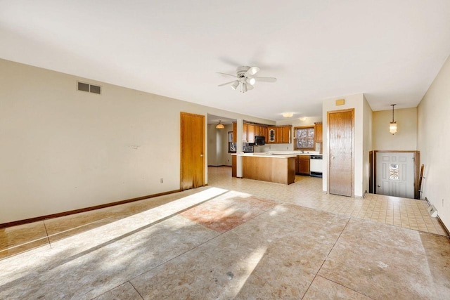 kitchen with ceiling fan, hanging light fixtures, white dishwasher, and light tile patterned flooring