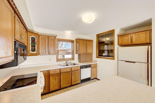 kitchen featuring white appliances and sink