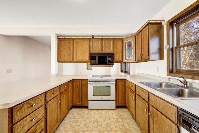 kitchen with sink, electric stove, dishwasher, and kitchen peninsula