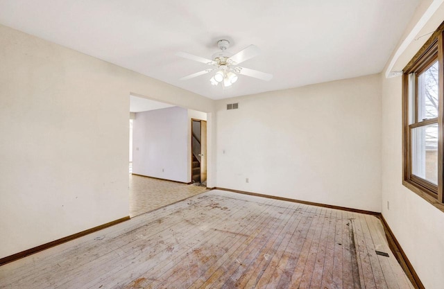 empty room featuring ceiling fan and light hardwood / wood-style flooring