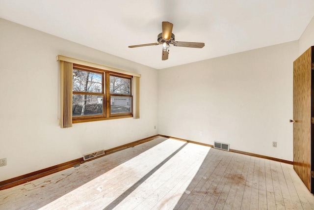 unfurnished room with ceiling fan and hardwood / wood-style flooring