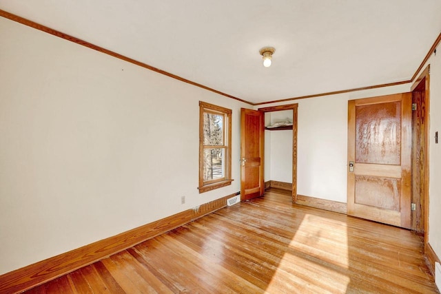 interior space featuring light hardwood / wood-style floors and crown molding