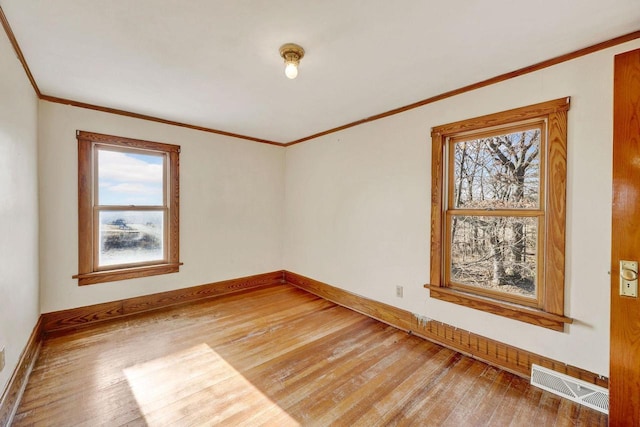 unfurnished room featuring hardwood / wood-style floors and crown molding