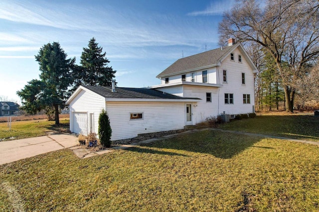 view of home's exterior with a lawn and a garage