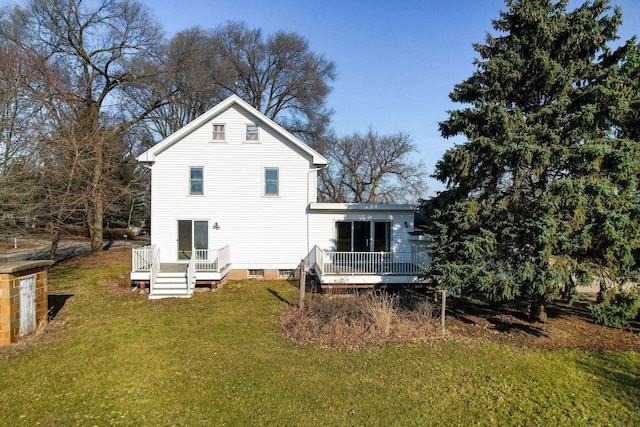 back of house featuring a lawn and a wooden deck