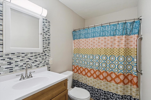 bathroom featuring vanity, decorative backsplash, and toilet