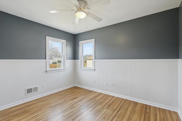 empty room featuring ceiling fan and light hardwood / wood-style flooring