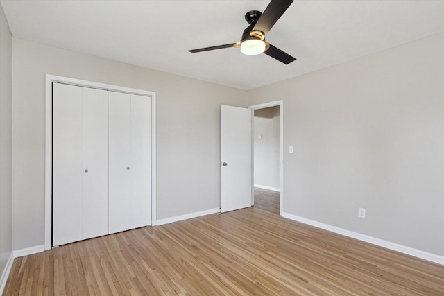 unfurnished bedroom featuring a closet, ceiling fan, and light hardwood / wood-style flooring