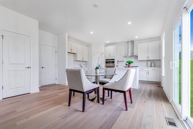 dining space featuring light hardwood / wood-style flooring