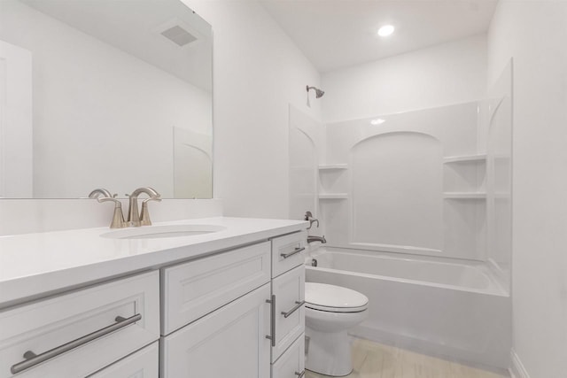 full bathroom featuring  shower combination, vanity, and toilet