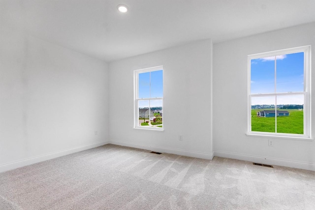 spare room featuring light colored carpet