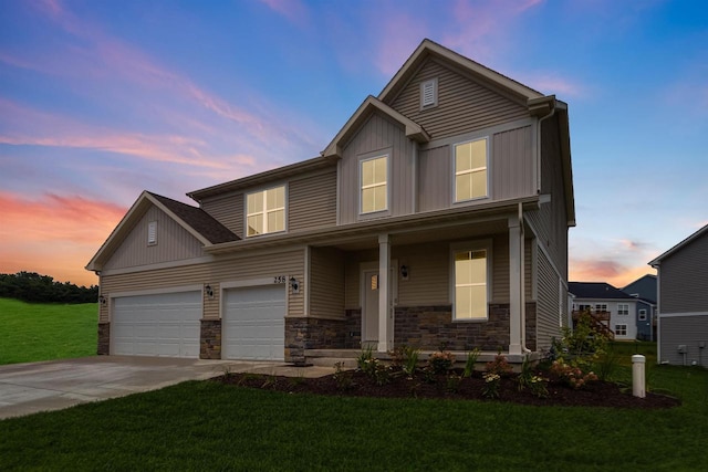 craftsman-style house featuring a garage and a lawn