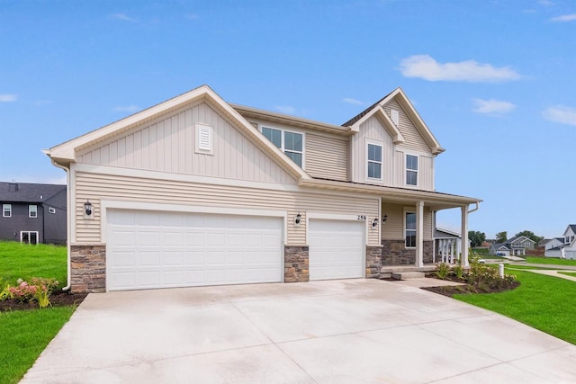 view of front of property with covered porch, a front yard, and a garage