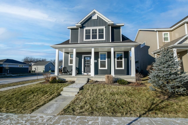 view of front of home with a front yard and a porch