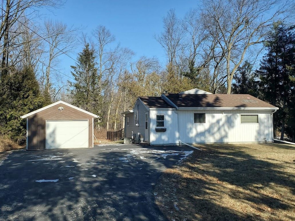 view of side of property with a garage and an outdoor structure