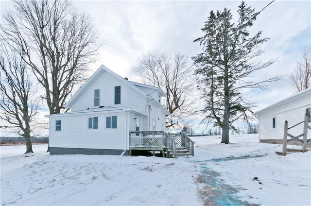 snow covered property featuring a deck