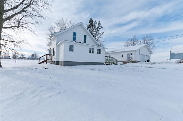 view of snow covered back of property