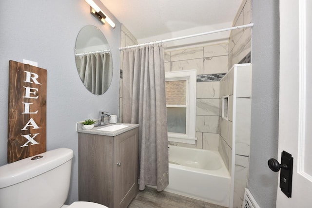 full bathroom featuring toilet, hardwood / wood-style flooring, shower / bath combo, and vanity