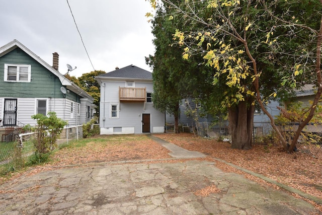 back of house featuring a balcony