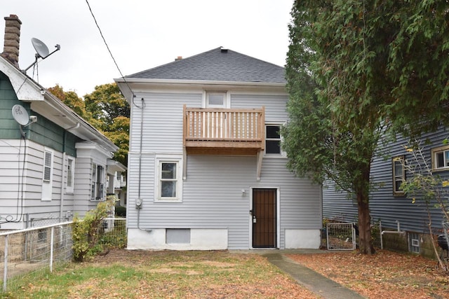 back of property featuring a balcony