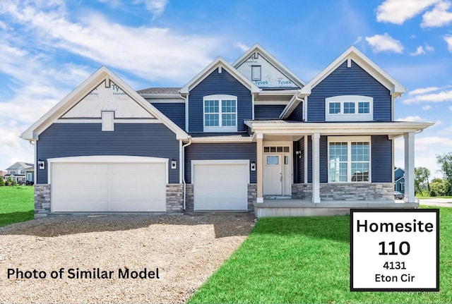 craftsman-style house with a porch, a front yard, and a garage