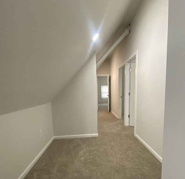 bonus room with carpet and vaulted ceiling