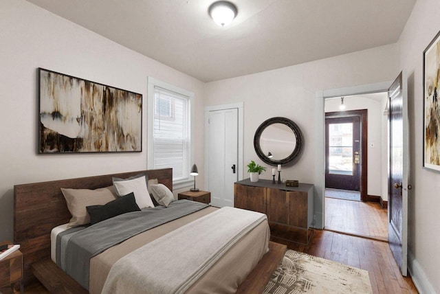 bedroom with hardwood / wood-style flooring