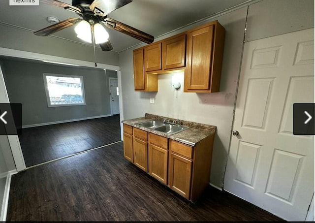 kitchen featuring sink, ceiling fan, beam ceiling, and dark wood-type flooring