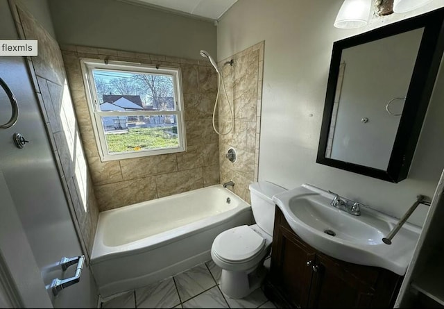 full bathroom with toilet, vanity, and tiled shower / bath