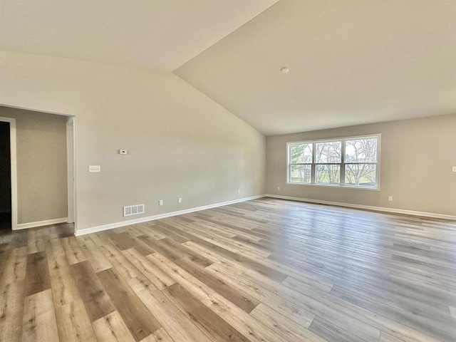 empty room featuring light hardwood / wood-style flooring and lofted ceiling