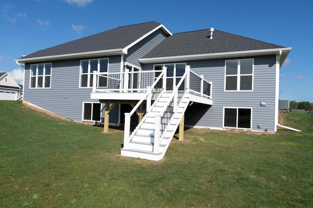 rear view of house featuring a yard and a wooden deck