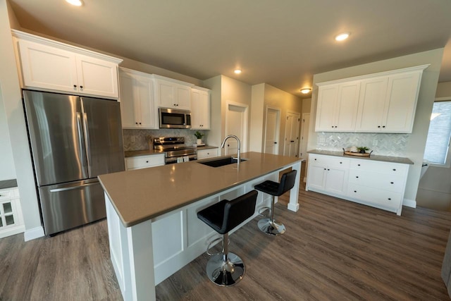 kitchen with stainless steel appliances, white cabinetry, and sink