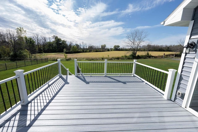 wooden deck with a rural view and a lawn