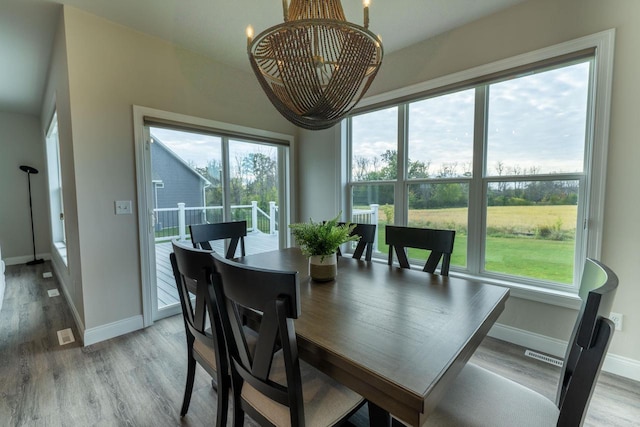 dining room featuring an inviting chandelier and hardwood / wood-style flooring