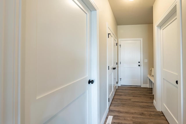 corridor with dark wood-type flooring