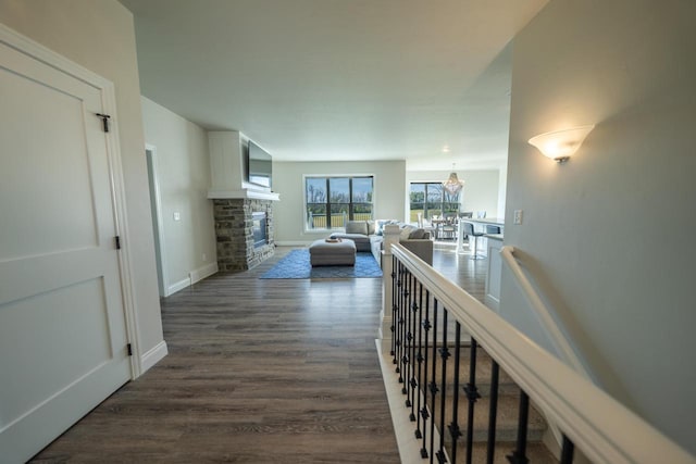 hallway with a notable chandelier and dark hardwood / wood-style flooring