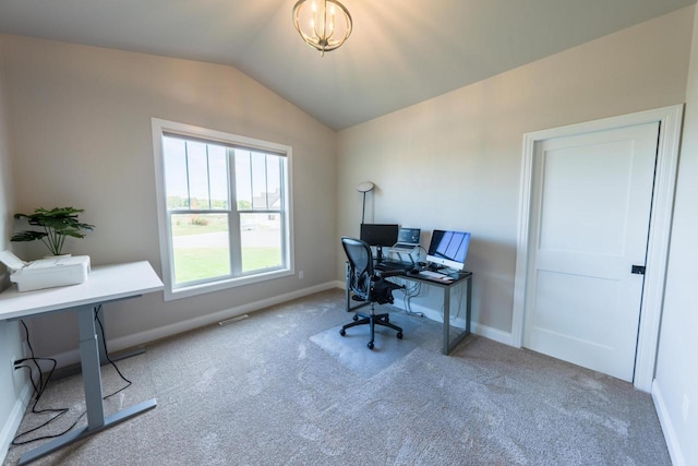 office space with an inviting chandelier, vaulted ceiling, and light carpet