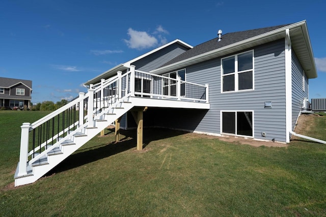 rear view of property with central air condition unit, a deck, and a yard