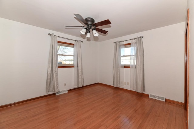 unfurnished room with ceiling fan and hardwood / wood-style floors